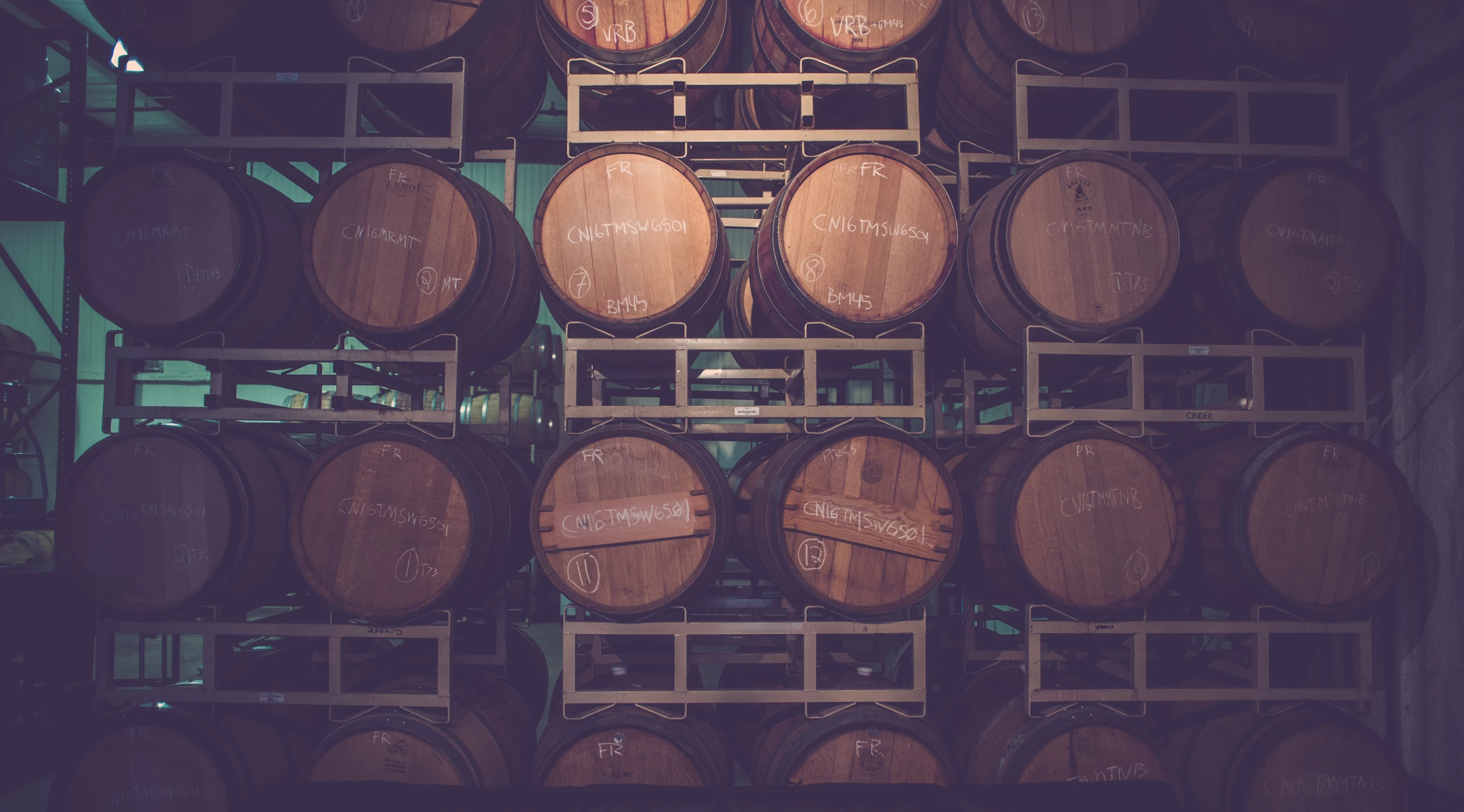 Rows of wine barrels in a wine cellar