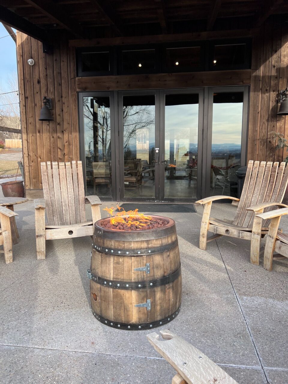 outdoor space at a winery with chairs and a fire barrel